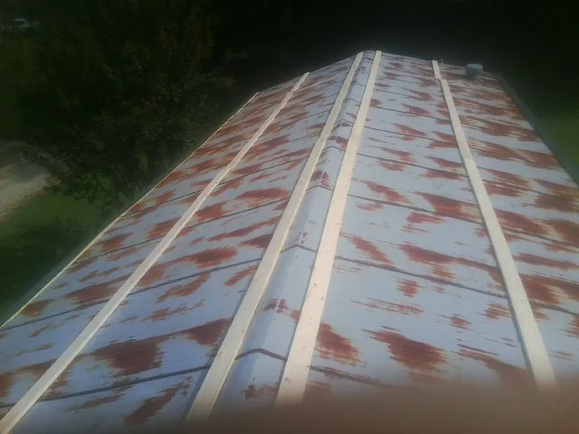 Rusted metal roof panels with new wood purlins before replacement — Storm Damage Roof Repair in Good Hope by Roofing Brothers