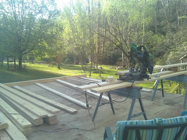 Miter saw and framing lumber on a deck under construction in Good Hope
