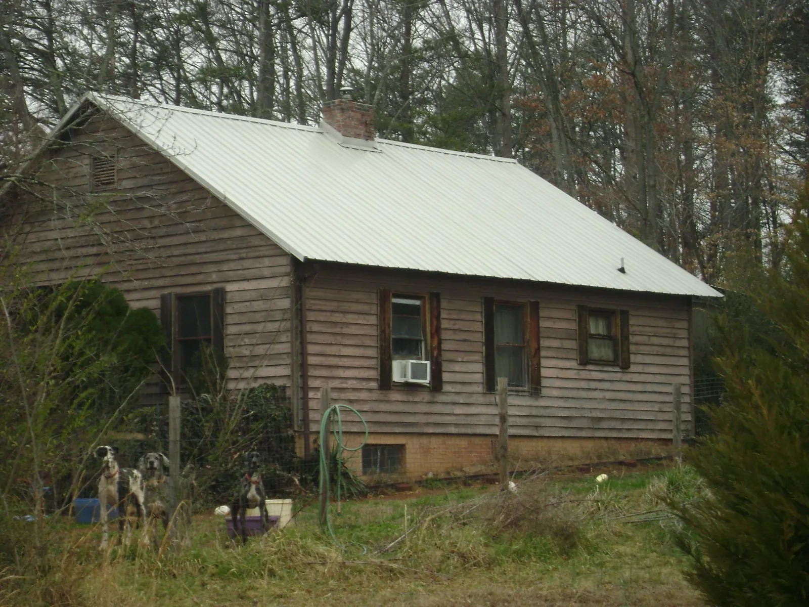 White metal roof on an old wood sided farmhouse, from a Asphalt Shingle Roof Repair job in Good Hope